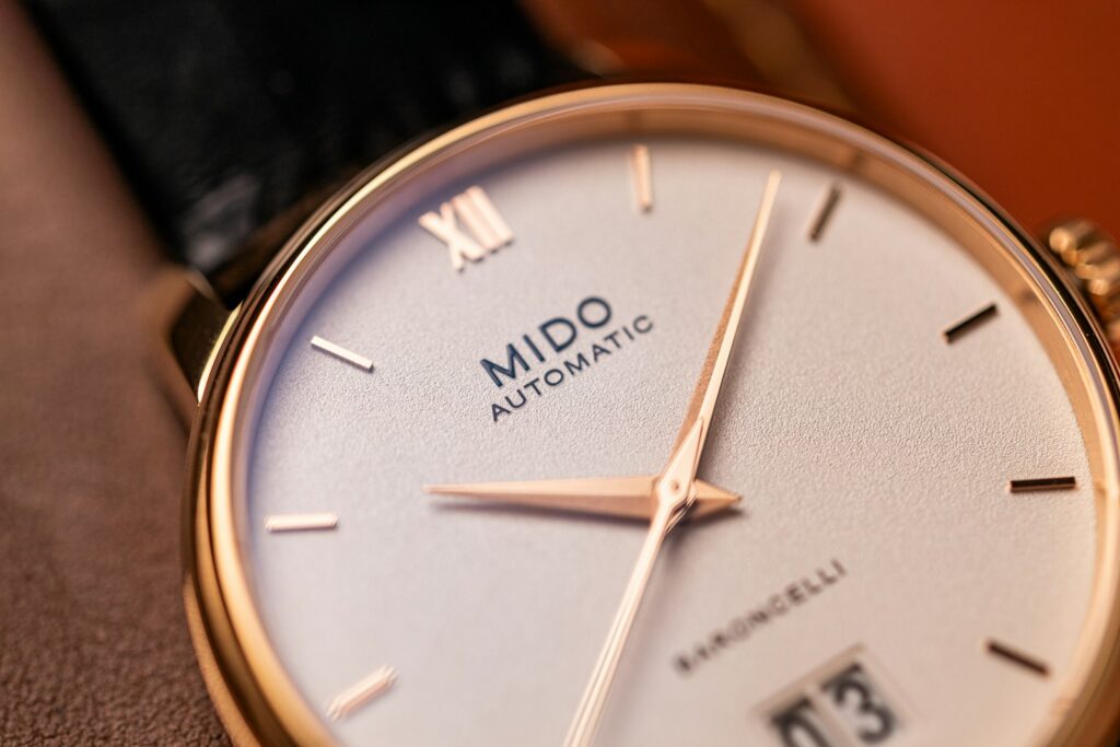 Close-up of a mido automatic wristwatch with date.